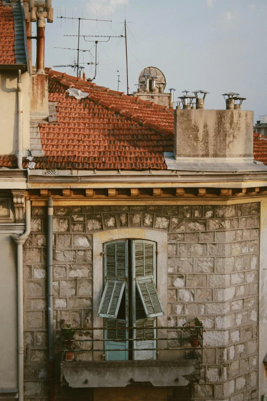 a couple of buildings that are next to each other, a picture, pexels contest winner, art nouveau, stone roof, late afternoon, neighborhood outside window, close up shot from the top