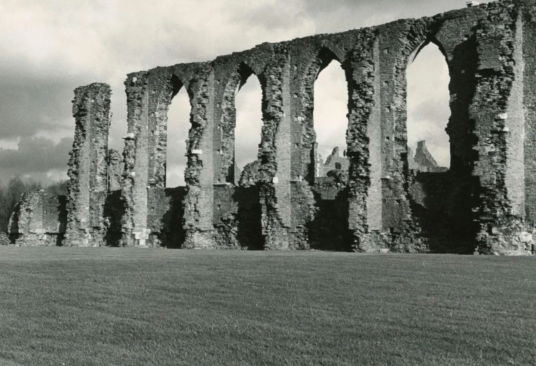 a black and white photo of the ruins of a church, a black and white photo, inspired by Thomas Struth, romanesque, aqueducts, 1950s photograph, long view, wall structure