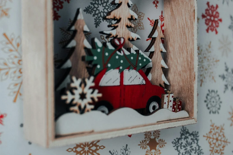 a picture of a red truck with a christmas tree in it, by Emma Andijewska, pexels contest winner, folk art, wooden frame, detail shot, textured 3 d, ilustration