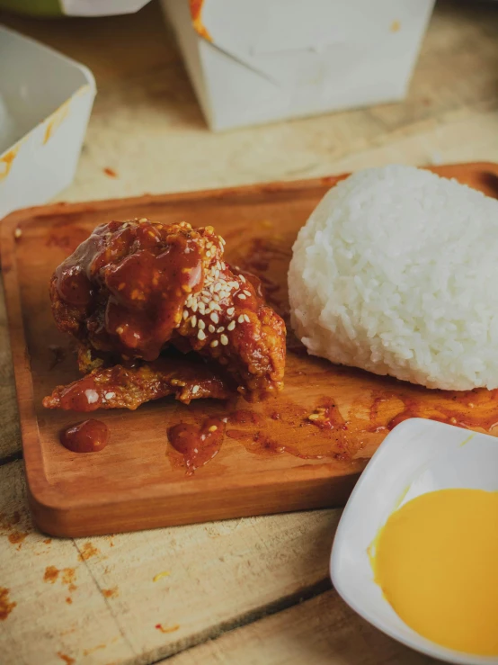 a wooden cutting board topped with rice and meat, inspired by Yosa Buson, unsplash, dau-al-set, jollibee city, thumbnail, battered, caramel