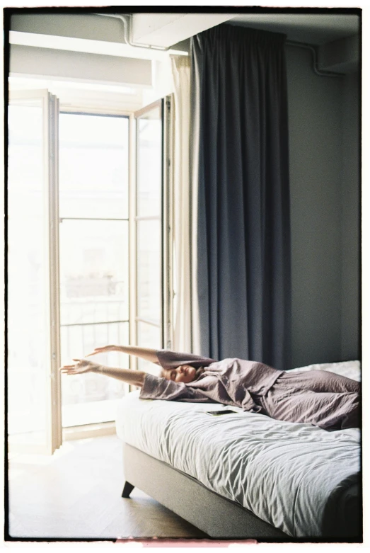 a person laying on a bed in front of a window, poster art, shot on hasselblad, :: morning, high res photograph, having a good time