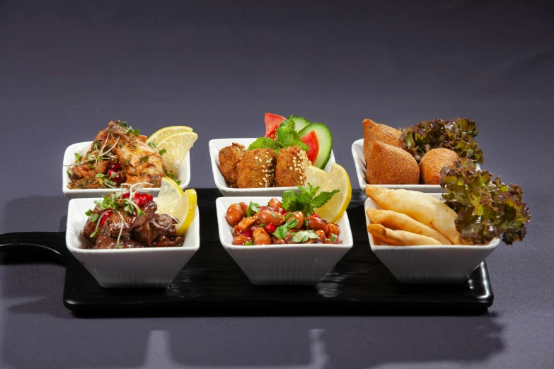 a close up of a tray of food on a table, caparisons, on grey background, arabian night, murata range