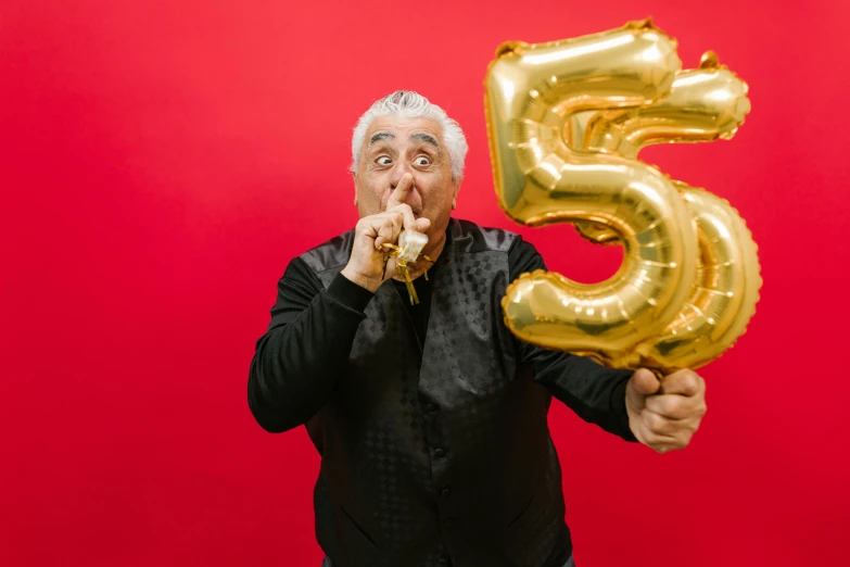 a man holding a golden balloon in front of his face, an album cover, pexels contest winner, 5 5 yo, guy fieri, celebrating a birthday, baris yesilbas