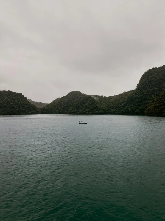 a boat in the middle of a large body of water, te pae, rainy environment, calmly conversing 8k, instagram picture