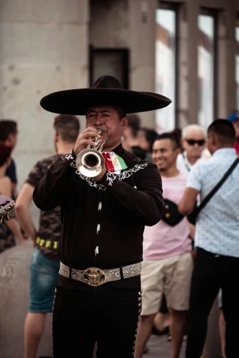 a man in a sombren playing a trumpet, by Alejandro Obregón, pexels contest winner, happening, wearing sombrero, with black horns instead of ears, people walking around, square