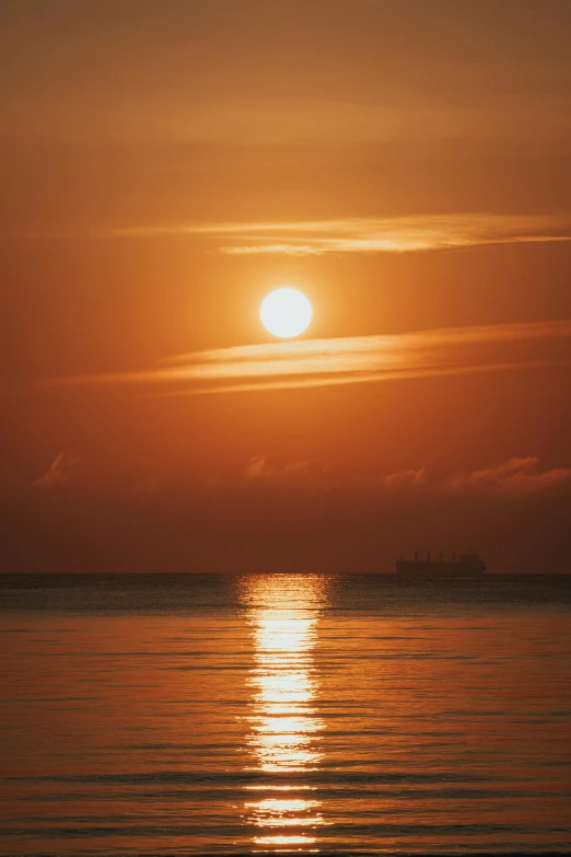 the sun is setting over a body of water, ship at sea, photograph, february), full frame image