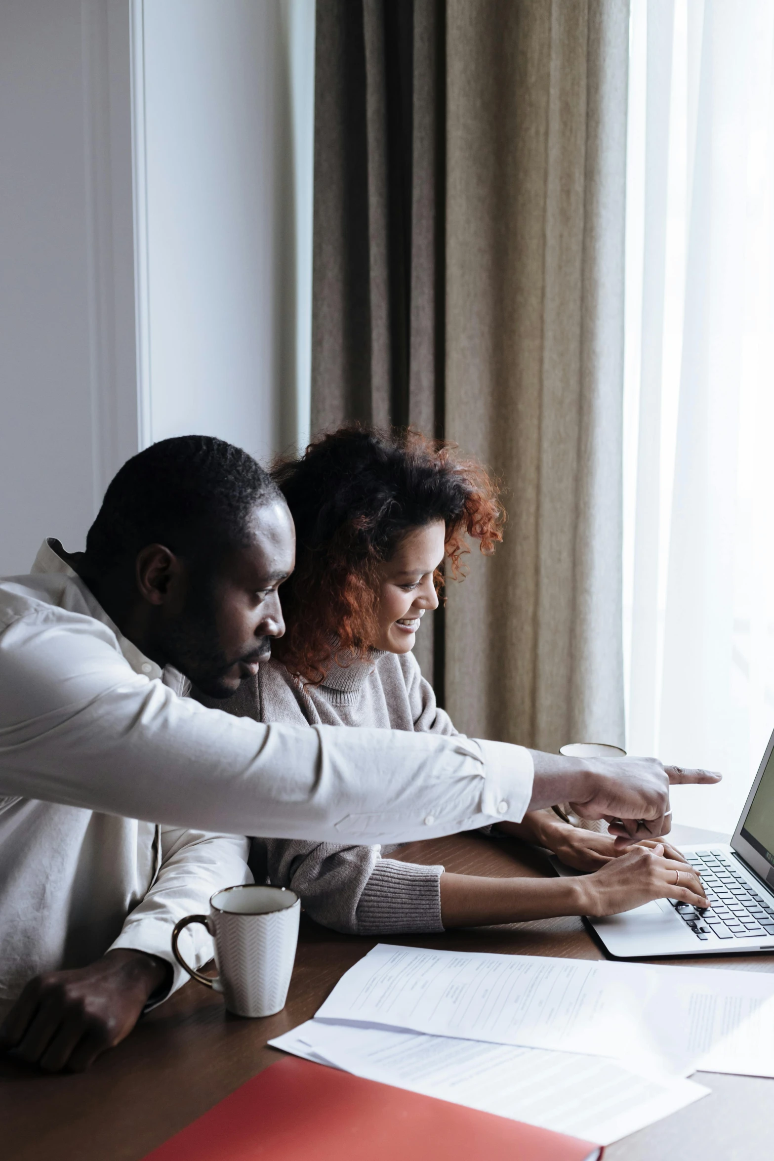 a couple of people sitting at a table with a laptop, by Carey Morris, pexels contest winner, afro tech, excel running on the computer, couple on bed, thumbnail