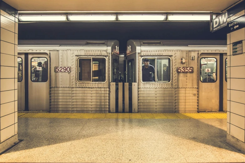a subway train pulling into a station with its doors open, by Carey Morris, unsplash contest winner, hyperrealism, square lines, toronto, vintage photo, new jersey