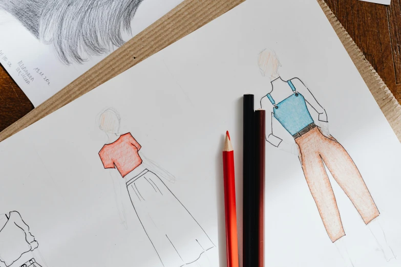 a couple of pencils sitting on top of a piece of paper, a child's drawing, by Olivia Peguero, trending on pexels, red and blue garments, fashion illustration, colouring - in sheet, wearing a crop top