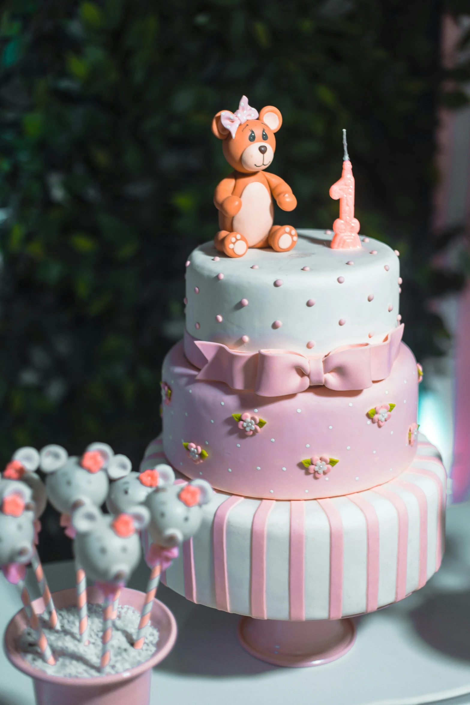 a pink and white cake with a teddy bear on top, by Lilia Alvarado, pexels, happening, at the party, nigth, grey, small