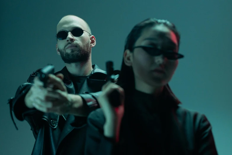 a man standing next to a woman holding a gun, cyberpunk art, pexels contest winner, matrix movie color grading, sunglasses on, demna gvasalia, [ theatrical ]