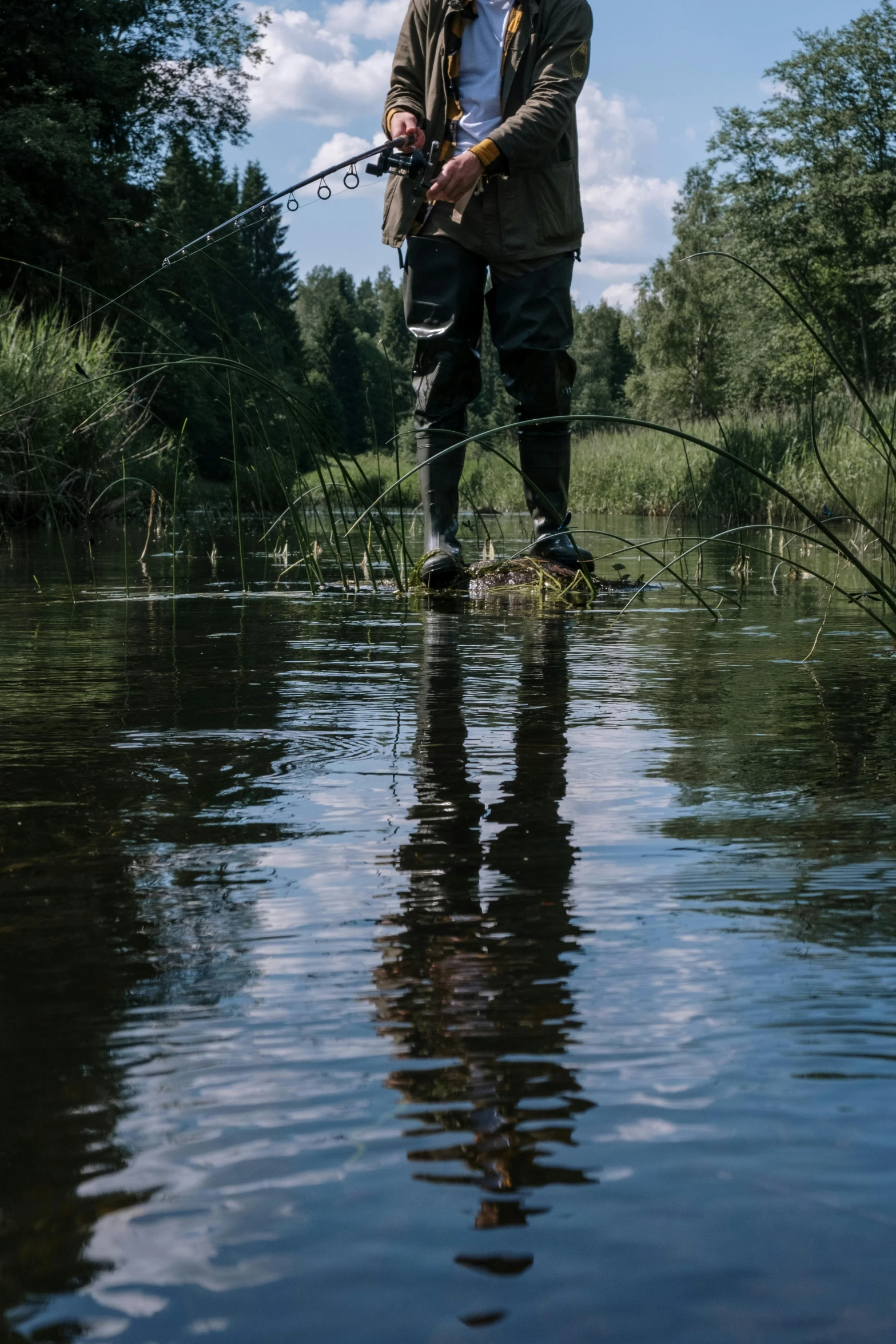 a man standing in the water with a fishing rod, by Anato Finnstark, unsplash, hurufiyya, boreal forest, feet in water, clothes floating, reflective chitin