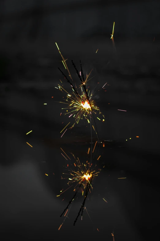 a couple of sparklers sitting on top of a table, black fire color reflected armor, houdini particles, clear reflection, shooting star