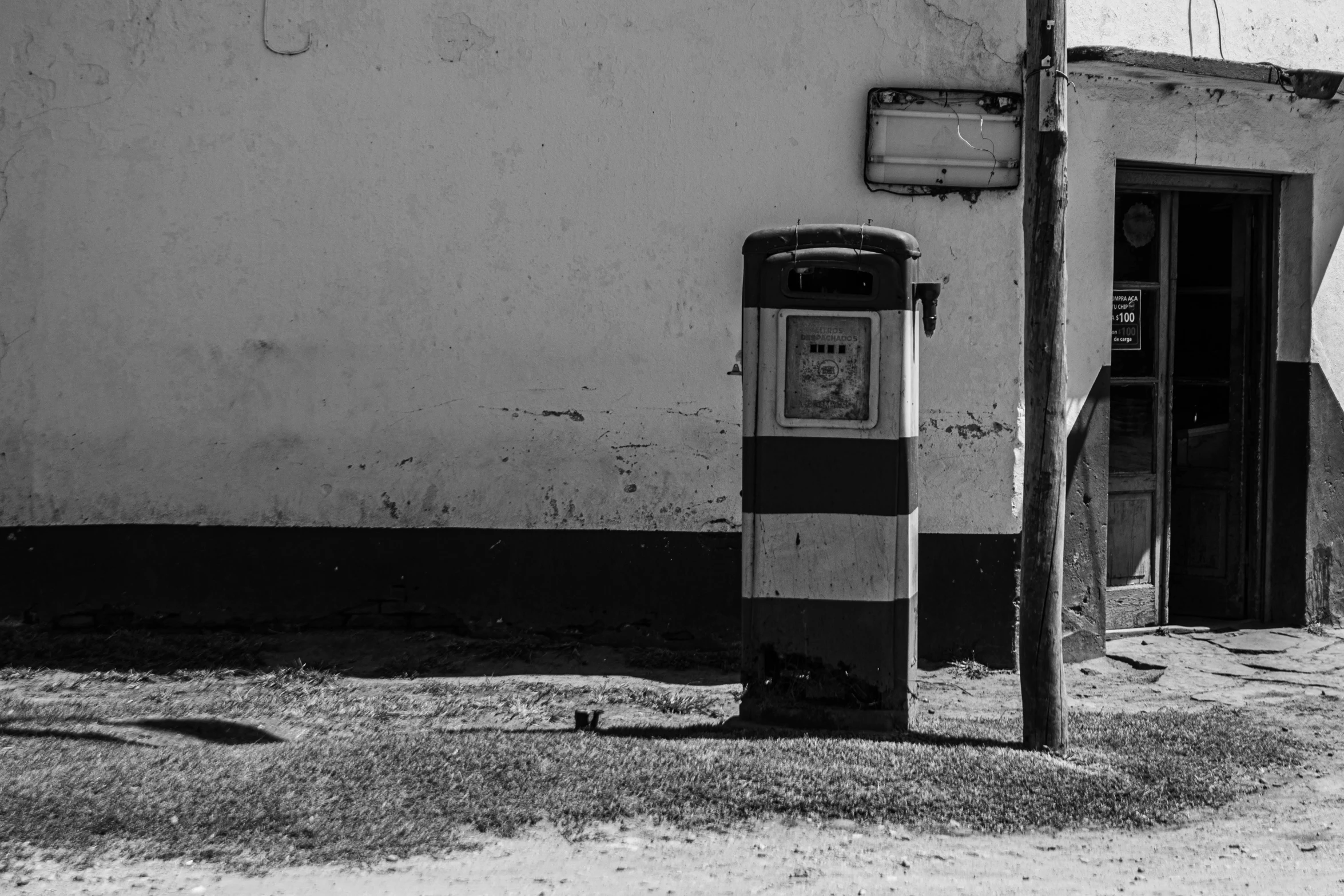 a black and white photo of an old gas pump, a black and white photo, by Dariusz Zawadzki, postminimalism, delivering mail, square lines, trending photo, in a sunny day