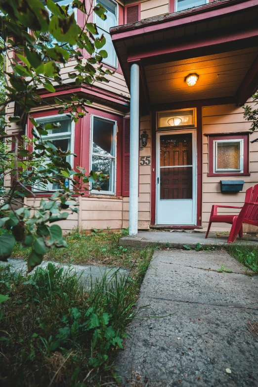 a red chair sitting in front of a house, by Matt Cavotta, unsplash, multiple stories, color image, high detailed photo, quaint