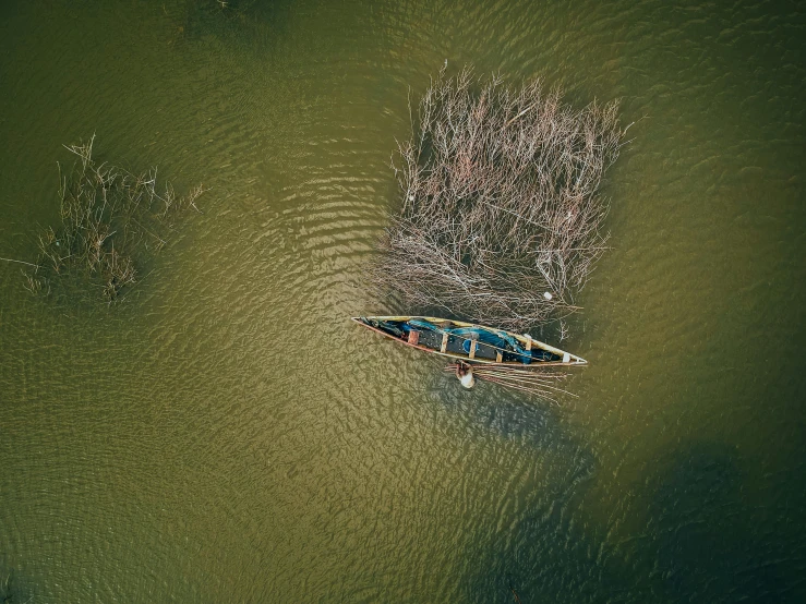 a small boat floating on top of a body of water, by Eglon van der Neer, pexels contest winner, hurufiyya, high - angle view, floods, color corrected, hunting