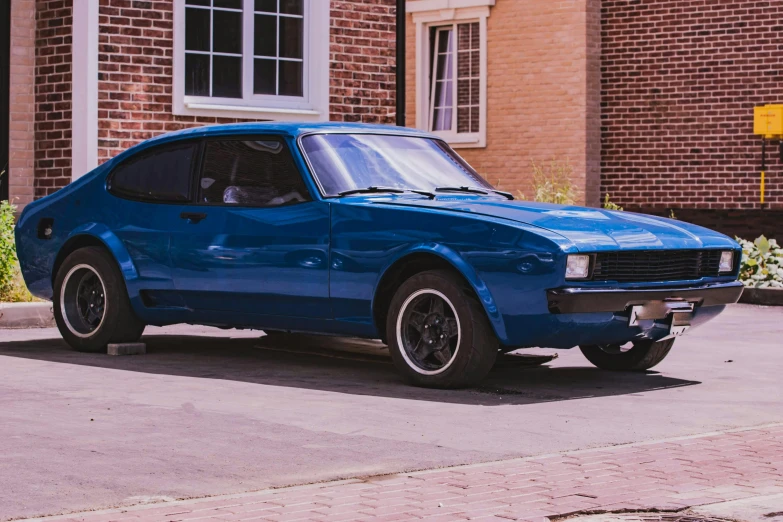 a blue car parked in front of a brick building, pexels contest winner, fantastic realism, mullet, old school fpr, regular build, swedish