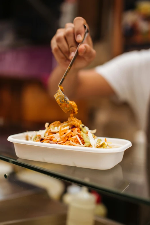 a close up of a person eating a plate of food, food court, carving, rectangle, vibrant and dynamic