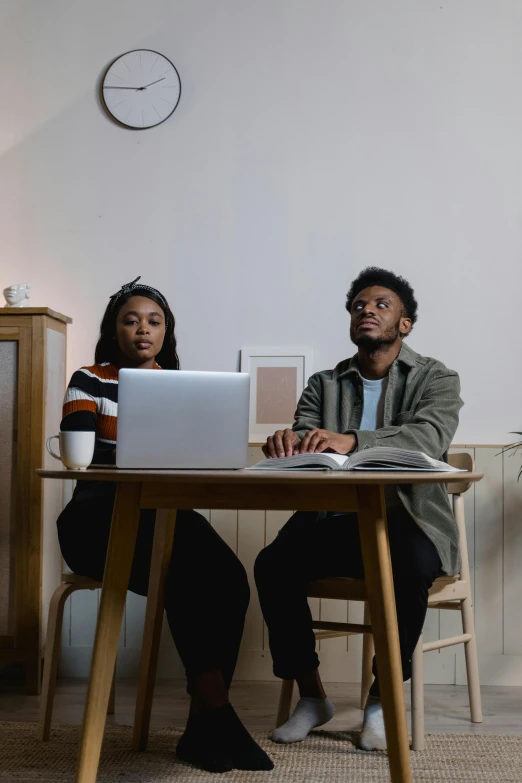 two people sitting at a table with a laptop, a portrait, trending on pexels, standing still, black people, ( ( theatrical ) ), full body image