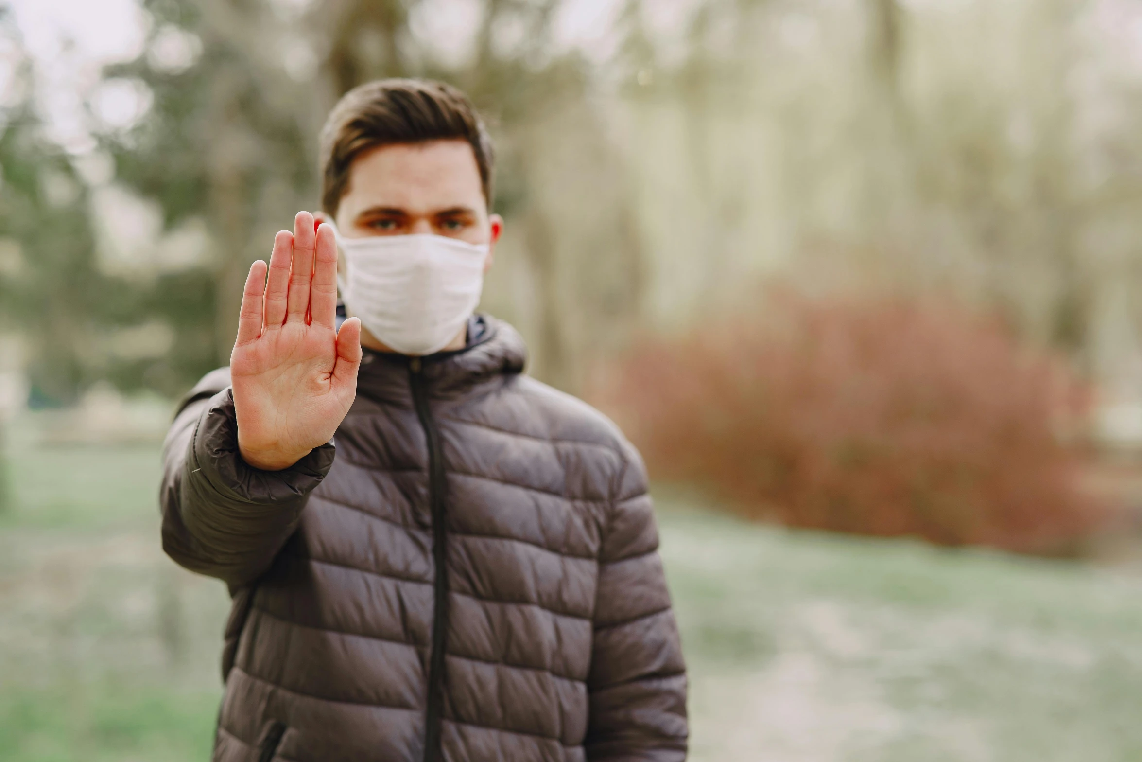 a man wearing a face mask making a stop sign, pexels, visual art, quack medicine, beautiful surroundings, avatar image, white bandages on fists