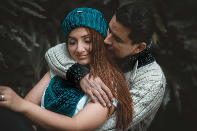 a man and a woman hugging each other, by Adam Marczyński, pexels contest winner, teal headband, knitted hat, avatar image, casual pose