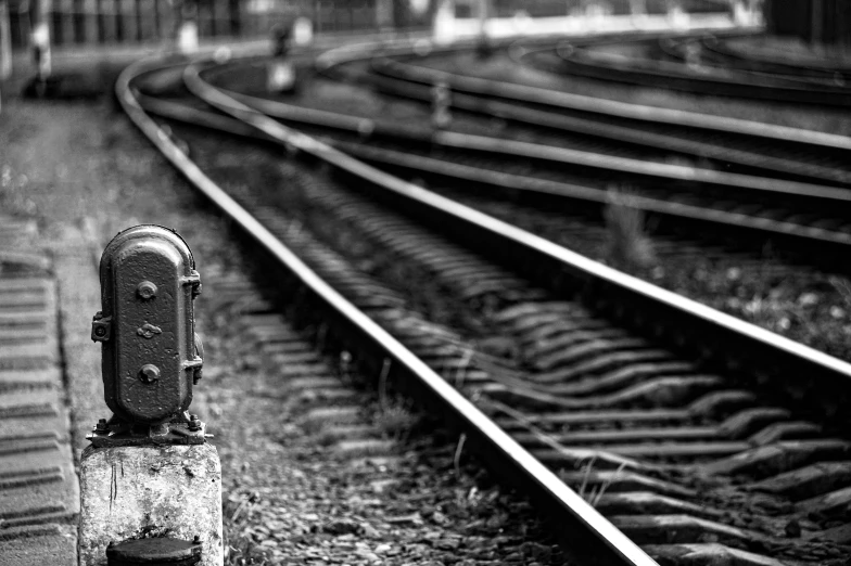 a black and white photo of a train track, a black and white photo, pexels, realism, switches, square lines, shallow depth of field hdr 8 k, one contrasting small feature