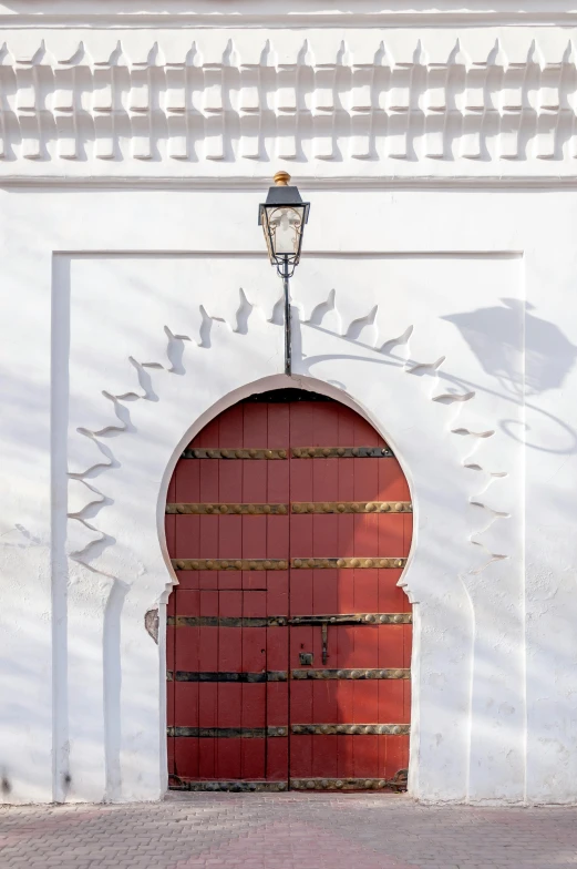 a red door in front of a white building, arabesque, architectural digest, hooded, maroon and white, seville