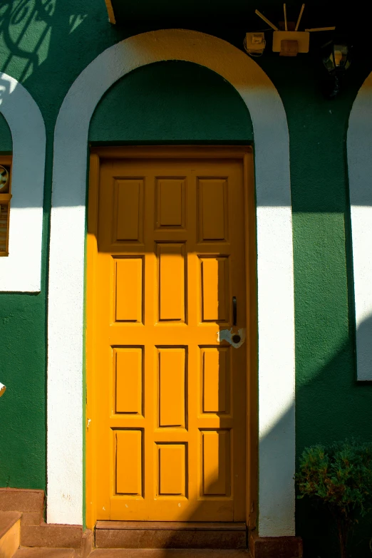 a green and white building with a yellow door, unsplash, folk art, rio de janeiro, green and orange theme, cottage close up, paul barson