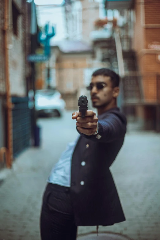 a man holding a gun on a city street, an album cover, pexels contest winner, sayem reza, action pose, headshot profile picture, security agent