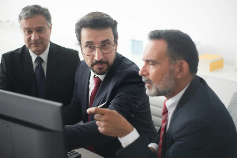 three men in suits looking at a computer screen, a photo, by Edi Rama, pexels, renaissance, kurdish lawyer, professional profile picture, older male, looking from shoulder