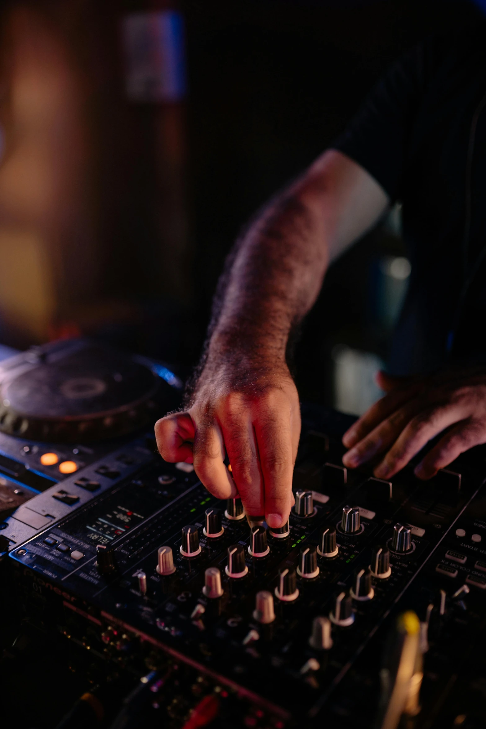 a dj mixing music in a dark room, pexels, hand on table, bartending, plain background, multiple stories