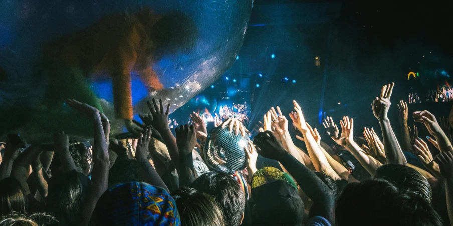 a crowd of people with their hands in the air, an album cover, by Matt Cavotta, pexels contest winner, happening, octopus wrestling with a sphere, at a rave, dmt water, sydney hanson
