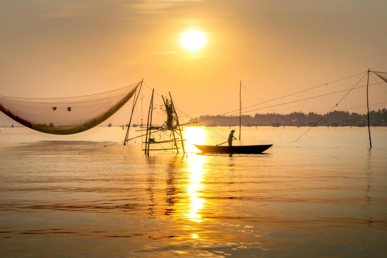 a boat that is sitting in the water, by Jan Tengnagel, pexels contest winner, asian sun, hoang long ly, golden hues, sail made of human skin