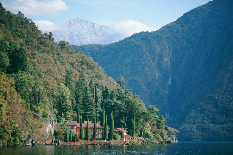 a body of water surrounded by trees and mountains, inspired by Peter Zumthor, pexels contest winner, renaissance, vouge italy, tall cypress trees, three michelin stars, in the style wes anderson