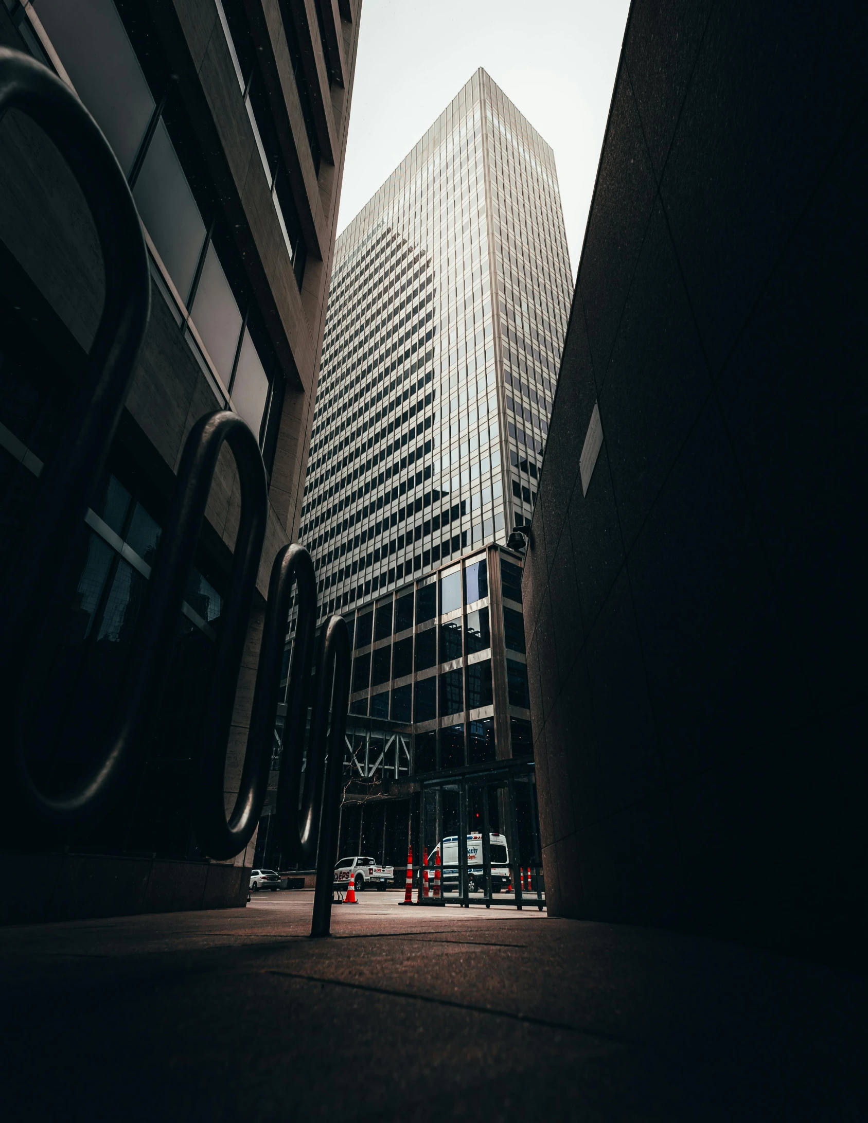 a tall building sitting in the middle of a city, unsplash contest winner, dark and modern, in a street, office building, low quality photo