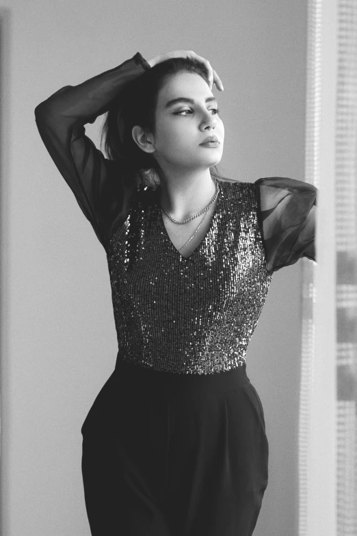 a black and white photo of a woman in a dress, a black and white photo, by Riza Abbasi, pexels contest winner, sequin top, 2 0 yo, cute elegant pose, smol