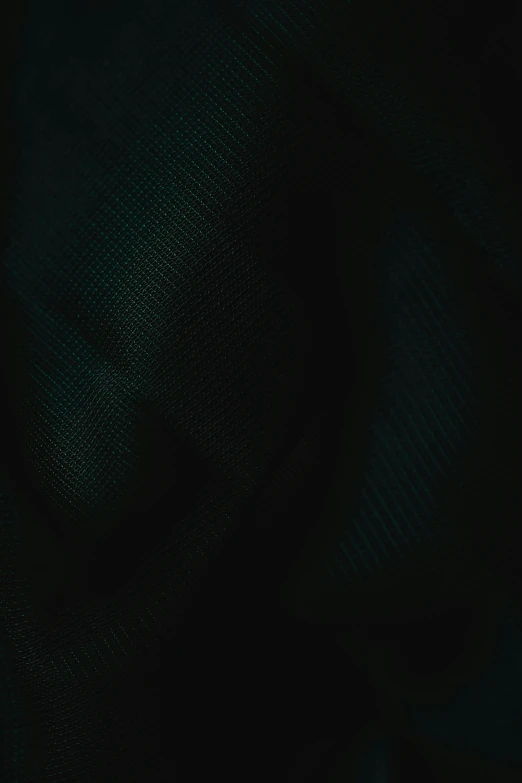 a close up of a person holding a cell phone, solid black #000000 background, moire, dark teal, slightly pixelated