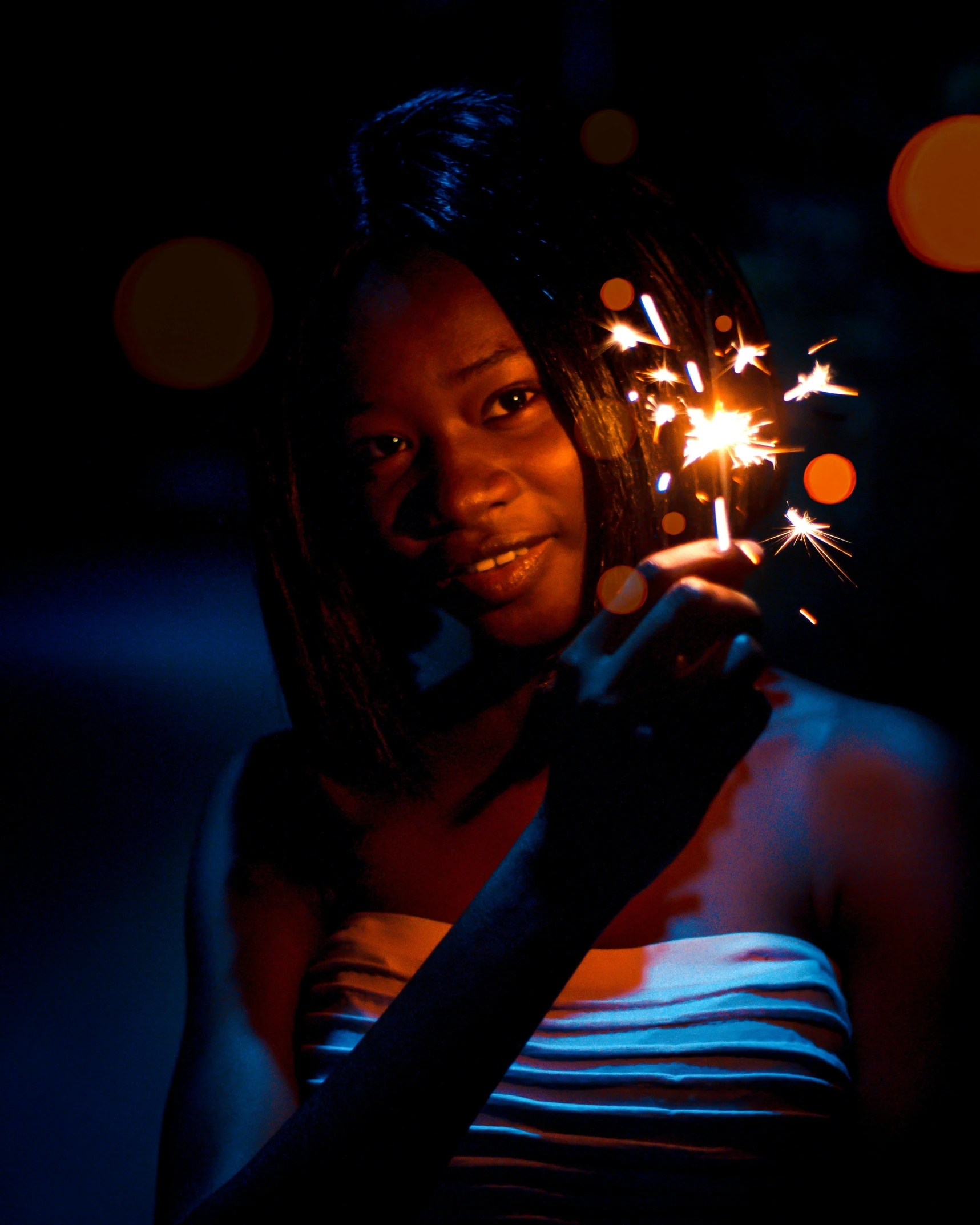 a woman holding a sparkler in her hand, by Chinwe Chukwuogo-Roy, art photography, portait image, medium format, multiple stories, brown skinned