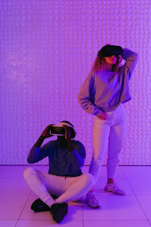 a couple of women standing next to each other, a hologram, trending on unsplash, interactive art, vr helmet on man, they are crouching, purple, smart textiles