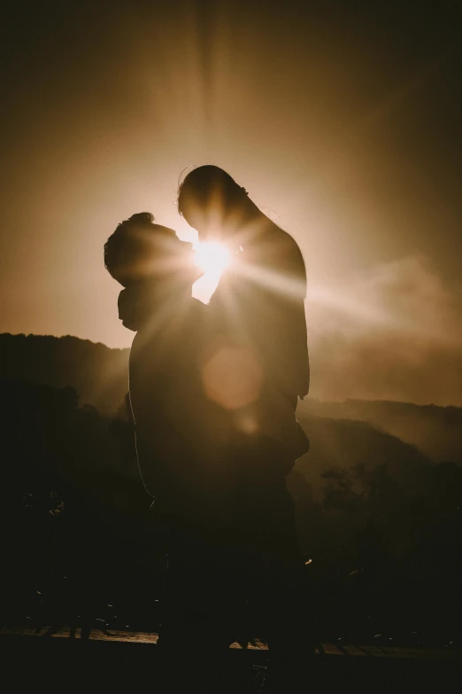 a couple standing next to each other in front of the sun, pexels contest winner, romanticism, making out, backlite, lgbtq, instagram post