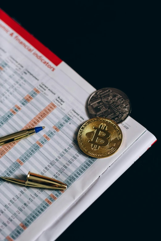 a pen sitting on top of a piece of paper next to a calculator, a digital rendering, by Carey Morris, trending on pexels, edible crypto, gold coins, thumbnail, textbook page