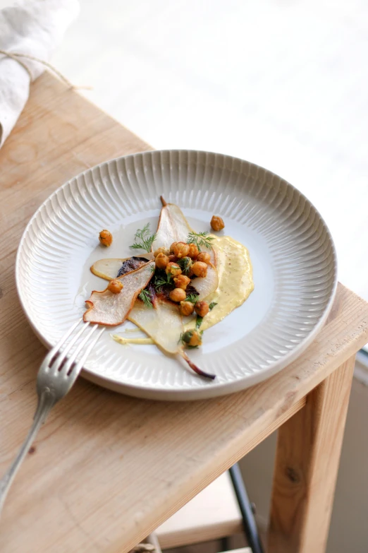 a plate of food sitting on top of a wooden table, inspired by Constantin Hansen, beige, lots de details, cuisine