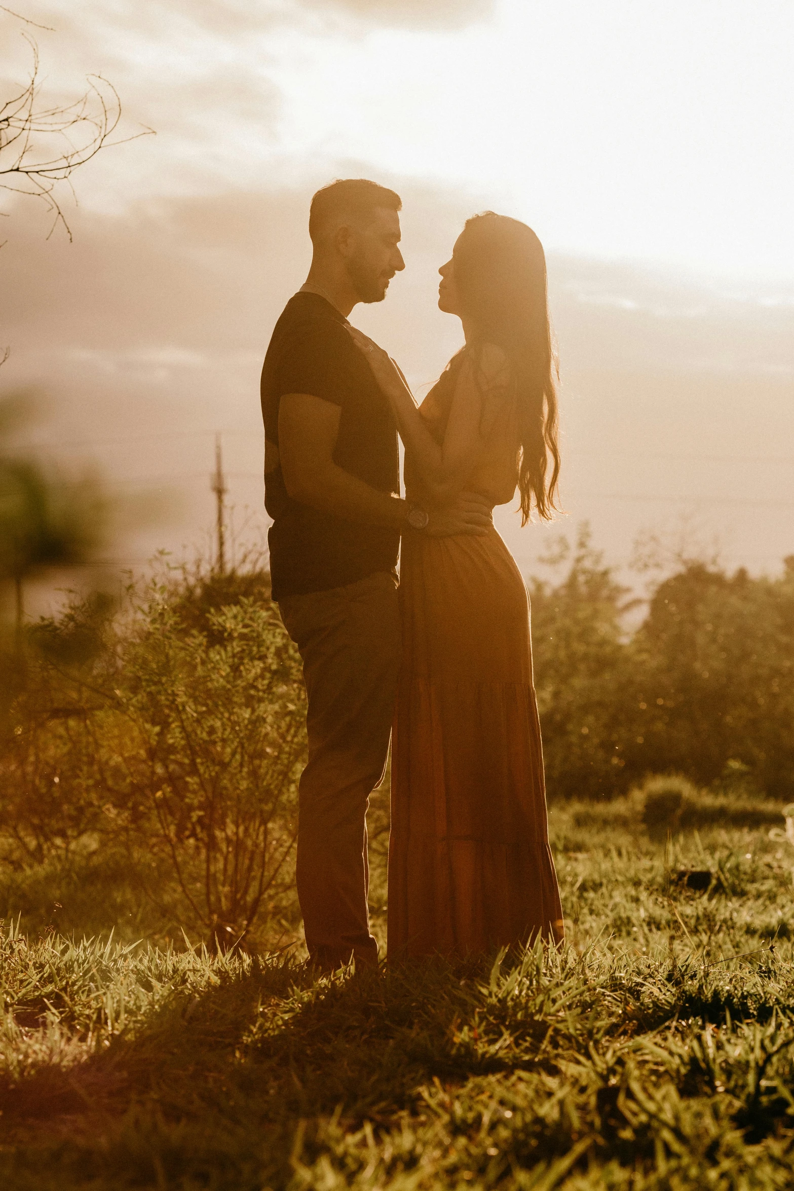 a couple standing next to each other in a field, pexels contest winner, beautiful backlit, overlooking, manuka, modelling