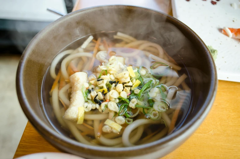 a close up of a bowl of food on a table, mingei, fan favorite, spiraling, a cozy, square