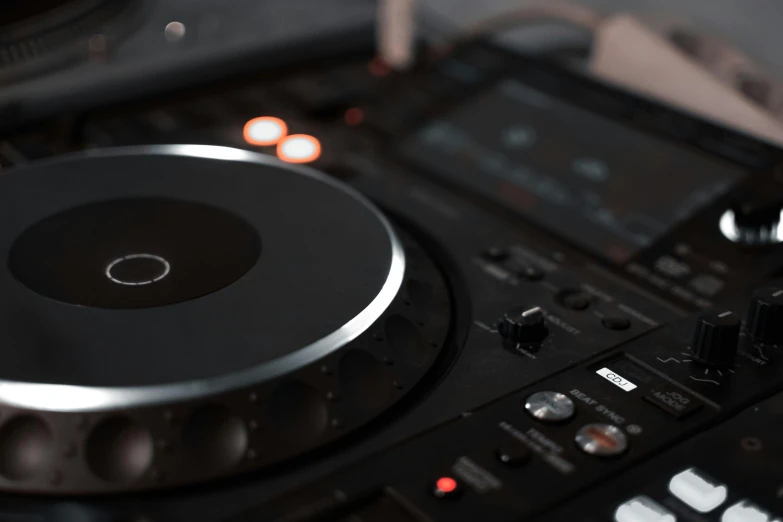 a dj controller sitting on top of a table, trending on pexels, private press, tannoy, black interface, round format, shot on sony a 7