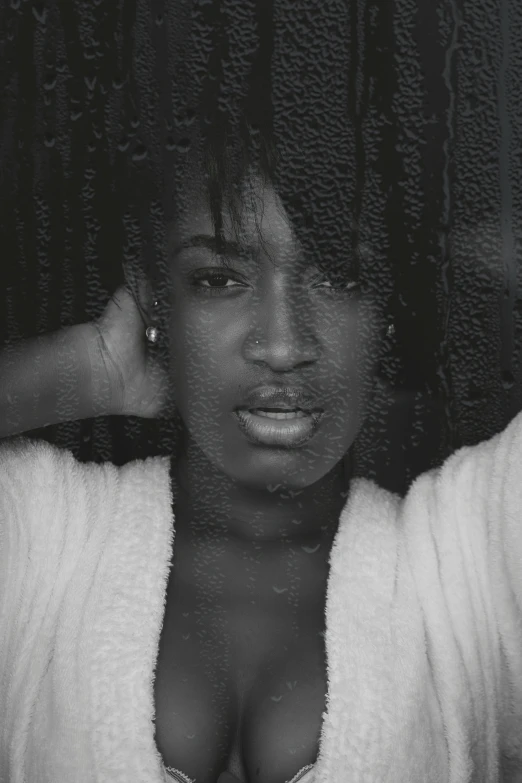 a black and white photo of a woman in a bathrobe, an album cover, unsplash, realism, black skin!!!, rainy; 90's photograph, androgyny, slightly pixelated