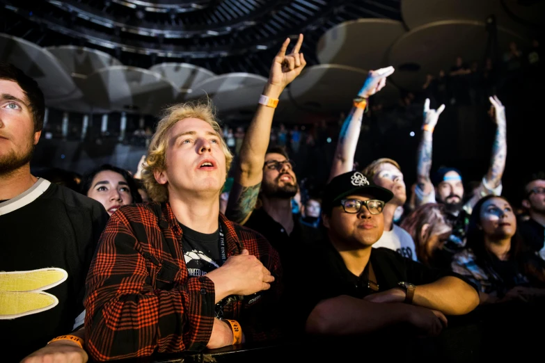 a group of people standing next to each other at a concert, jody highroller, holding it out to the camera, owen klatte, looking off into the distance