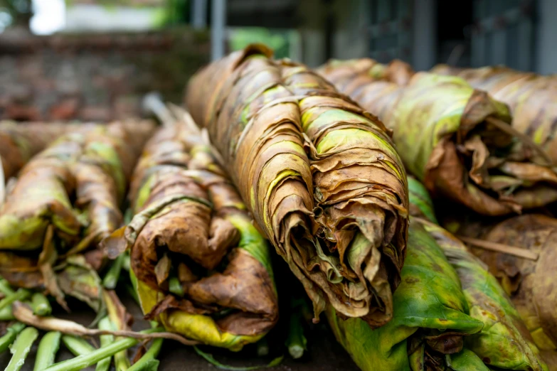 a bunch of bananas sitting on top of a table, chest covered with palm leaves, bao phan, very crispy, thumbnail