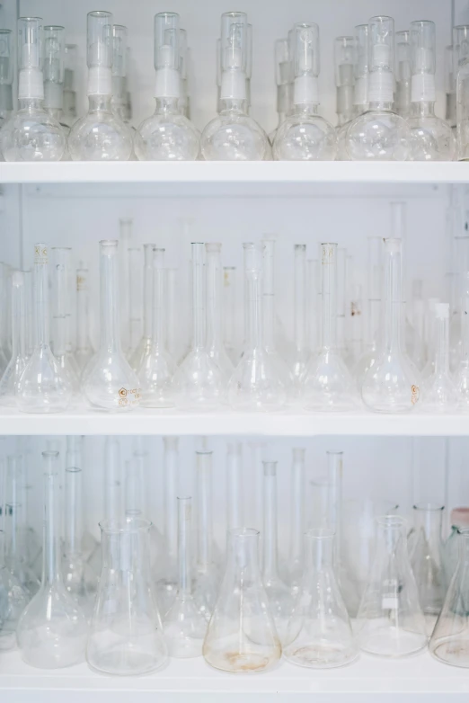 a shelf filled with lots of empty wine glasses, unsplash, analytical art, wearing a white lab coat, white wall coloured workshop, tubes, 1792