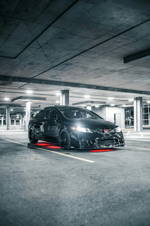 a black car parked in a parking garage, by Jason Felix, pexels contest winner, auto-destructive art, honda civic, red leds, full pose, fit build